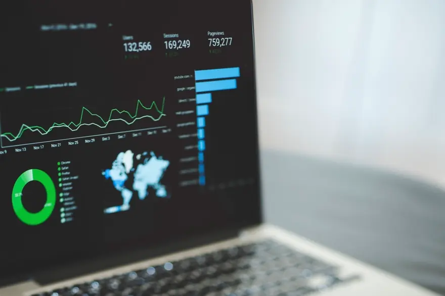 Laptop screen showing a dark analytics dashboard with engagement charts